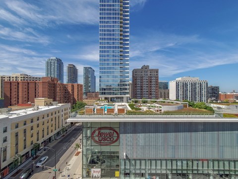 A cityscape with a Jewel USCO building in the foreground.