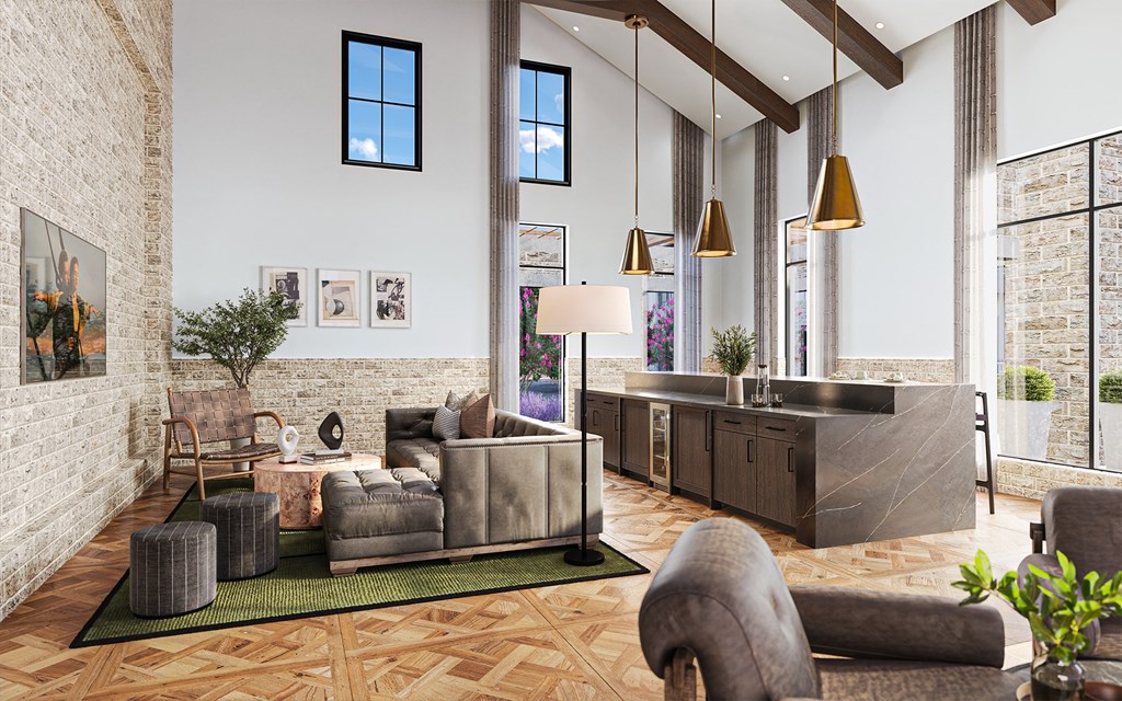 A living room with a grey couch and a green rug.