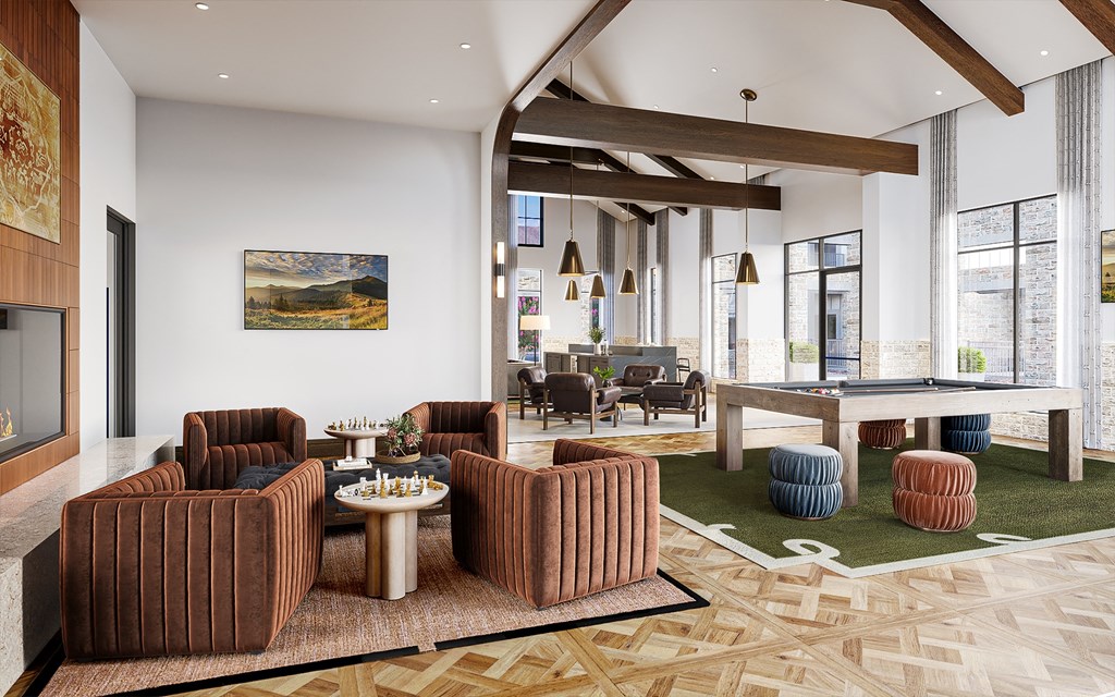 A living room with a brown couch and a painting on the wall.