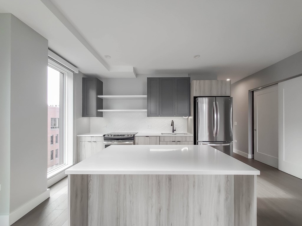 A modern kitchen with a large island in the center.