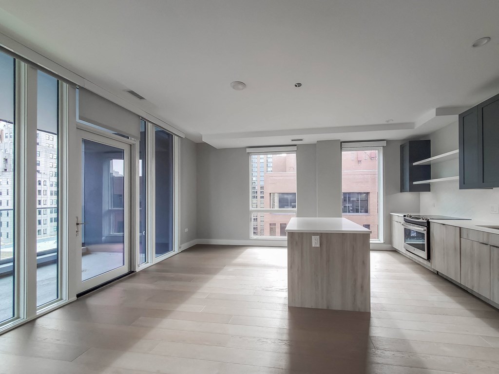 A spacious kitchen with a large island in the middle.