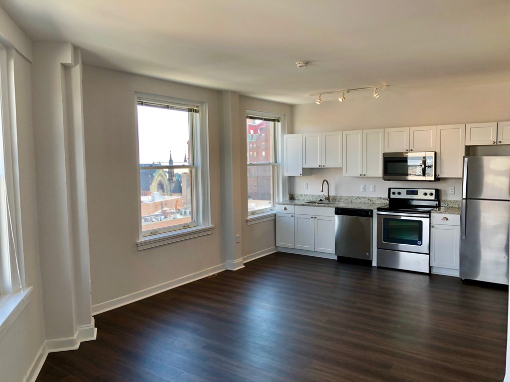 A kitchen with white cabinets and stainless steel appliances.