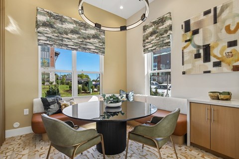 A dining room with a table and chairs.