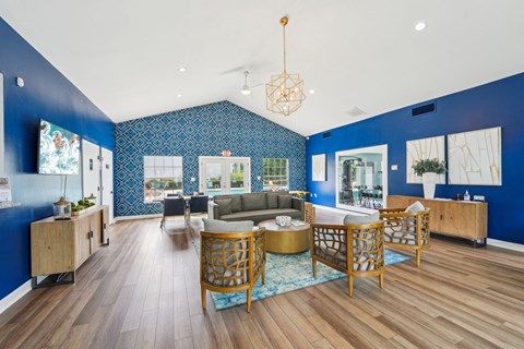 A living room with a blue wall and wooden furniture.