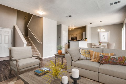 A living room with a couch, chair, and a coffee table.