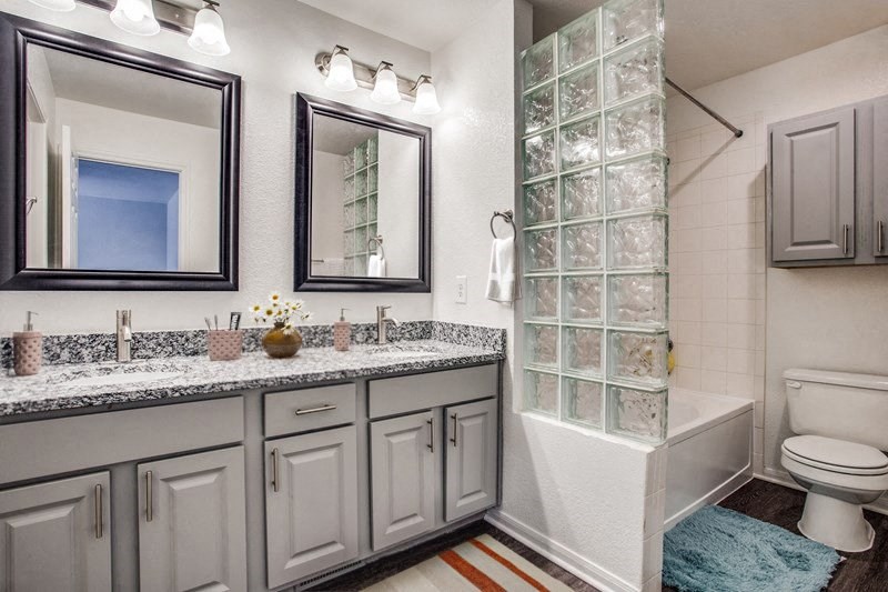 a bathroom with a shower and a sink and a toilet