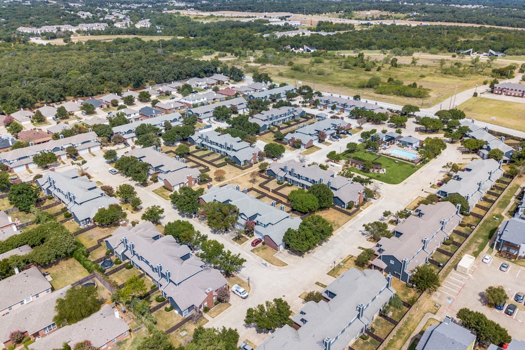 an aerial view of a neighborhood with houses and trees