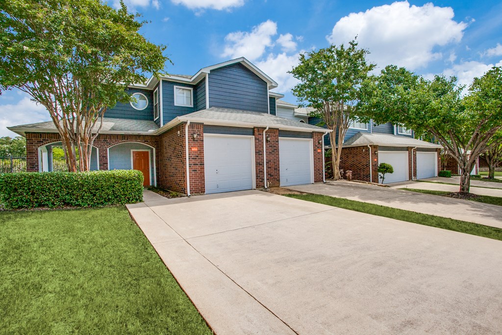 a blue house with a garage and a driveway