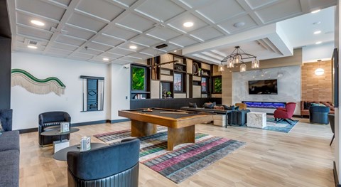 A modern living room with a wooden floor and a variety of seating options.