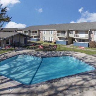 a swimming pool in front of an apartment building