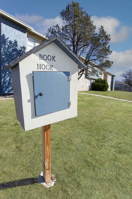 a blue and white mailbox in front of a house