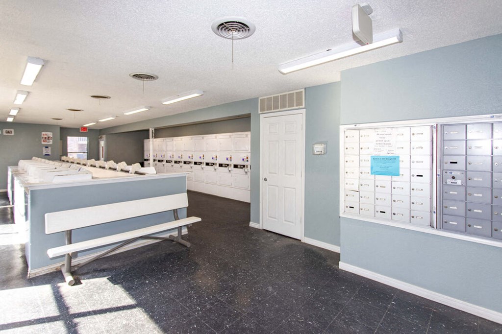 a locker room with a bench and mailboxes
