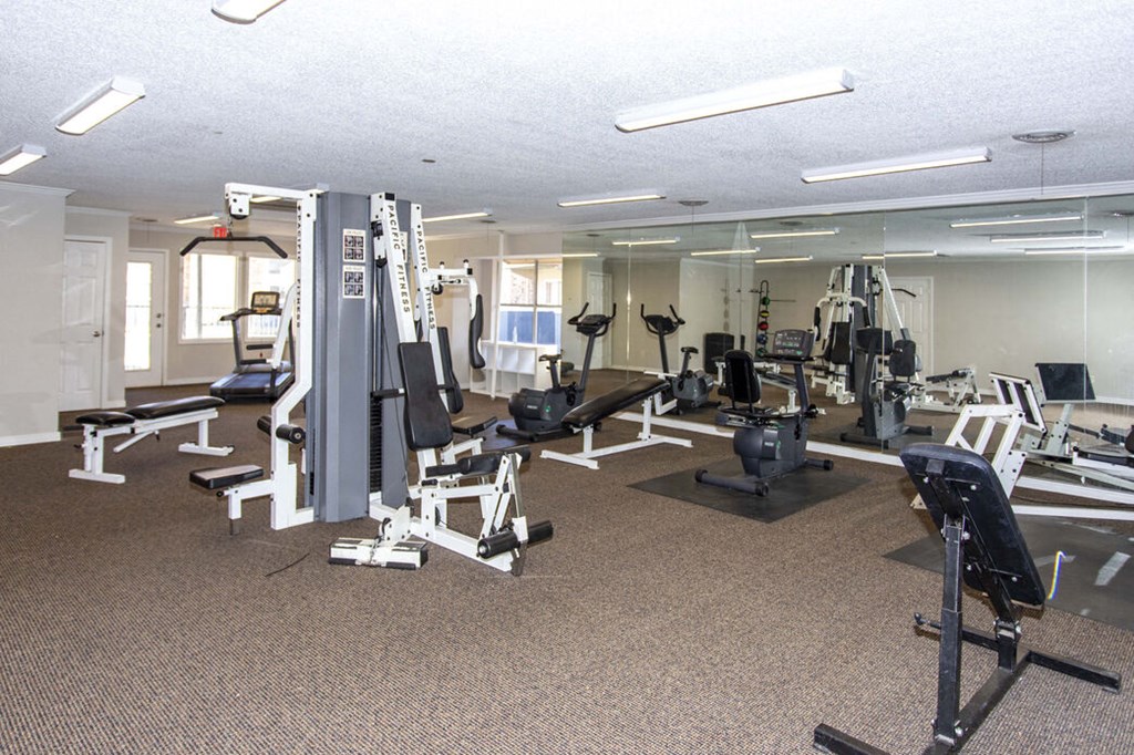 a gym with cardio equipment and weights in a building