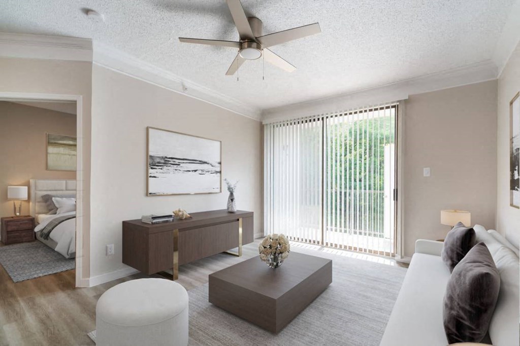 a living room with a couch and a ceiling fan