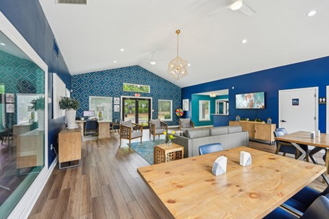 A blue and white themed cafe with wooden tables and chairs.