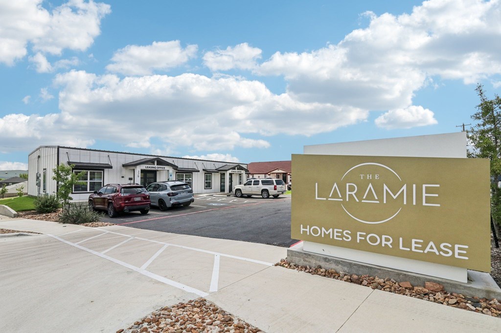 The Laramie Homes for Lease sign in front of a building.