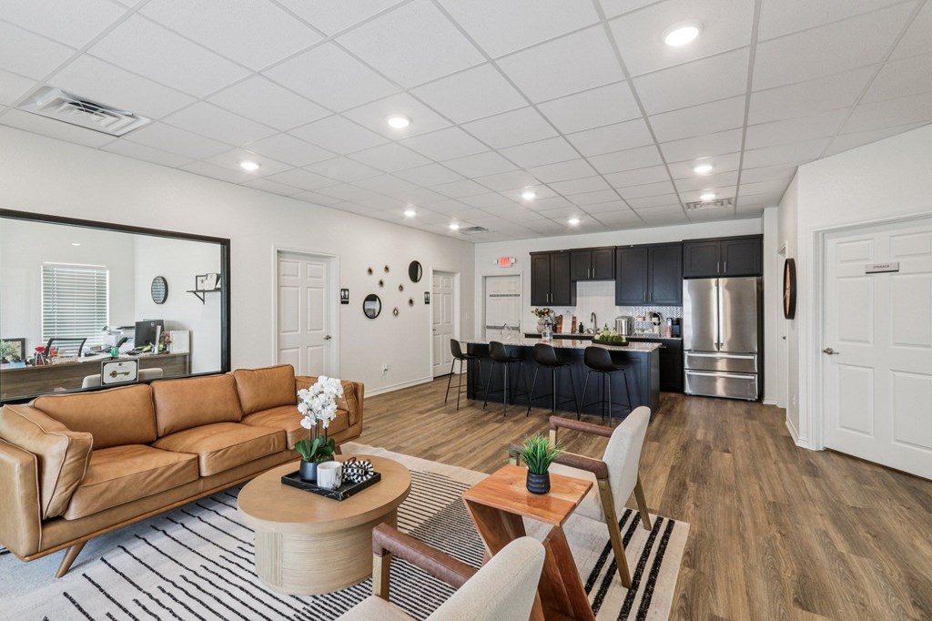 A modern living room with a brown leather couch and a wooden coffee table.
