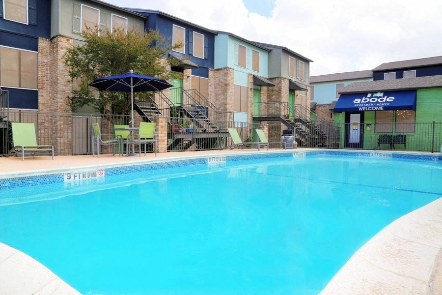 a large swimming pool with a building in the background
