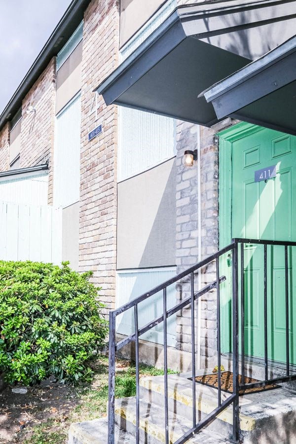 the front door of a building with a green door
