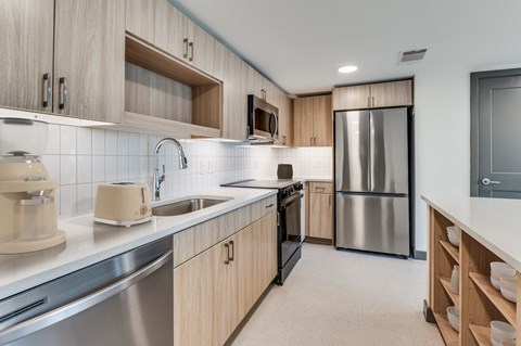A modern kitchen with wooden cabinets and stainless steel appliances.