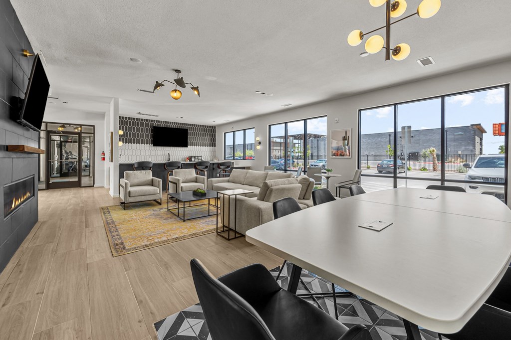 a spacious living room with couches and chairs and a white table