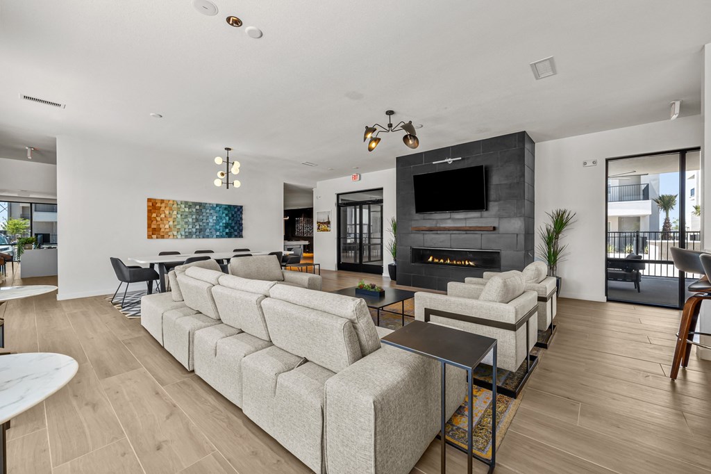 a living room with couches and chairs and a fireplace