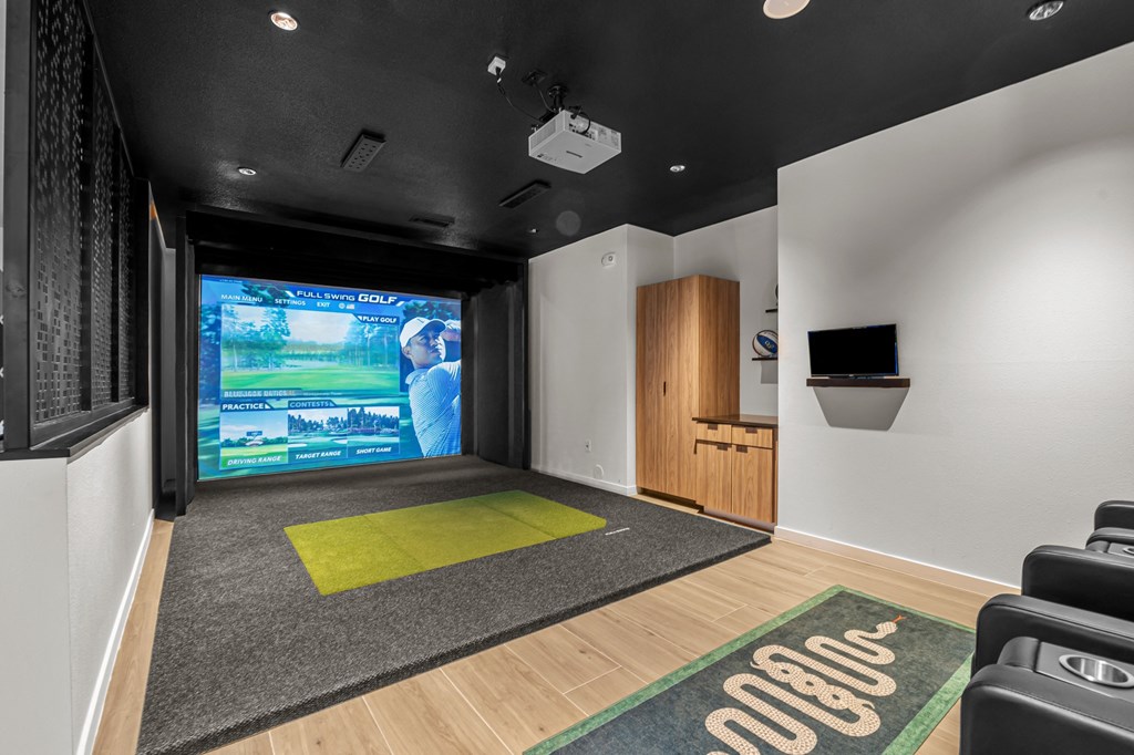 a workout room with a large screen tv and a yoga mat