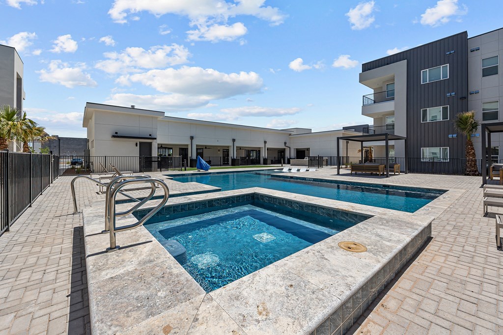 a swimming pool with a building in the background