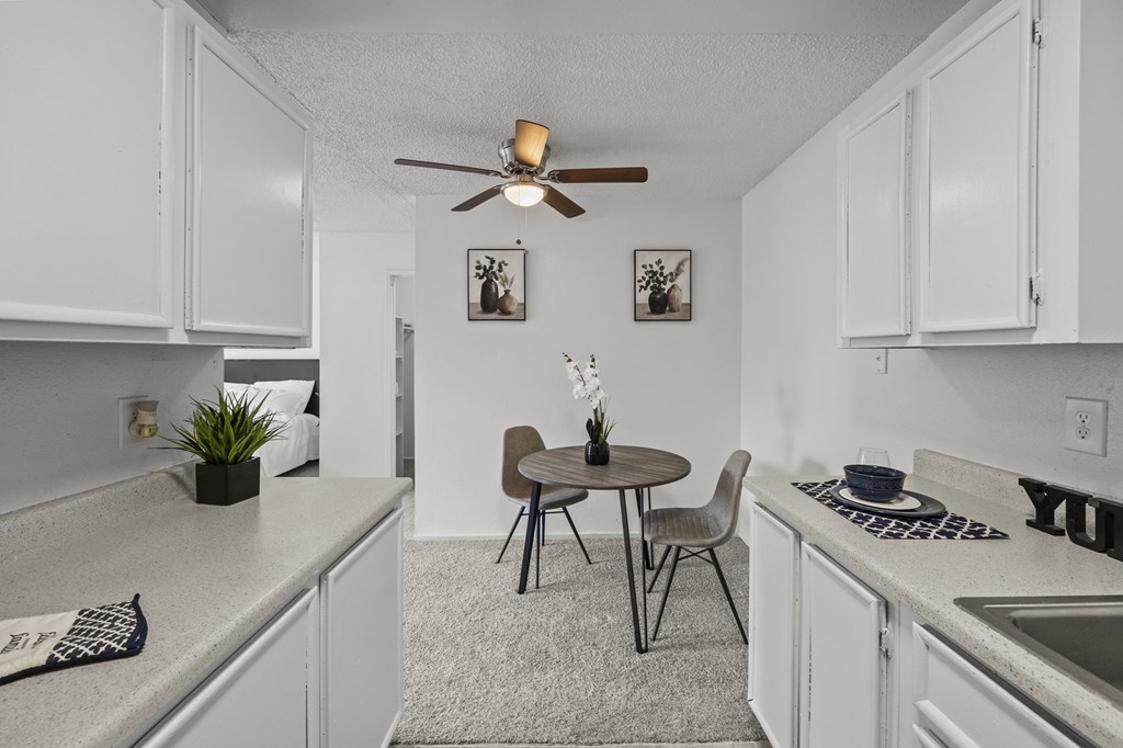 A small kitchen with a table and chairs.