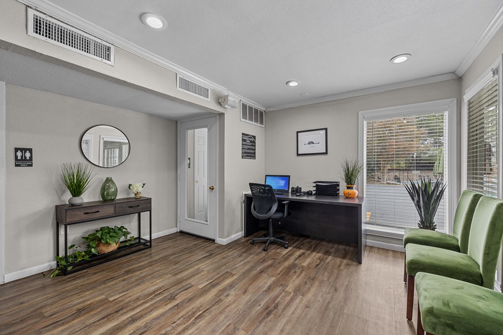 a home office with a desk and a chair and a window