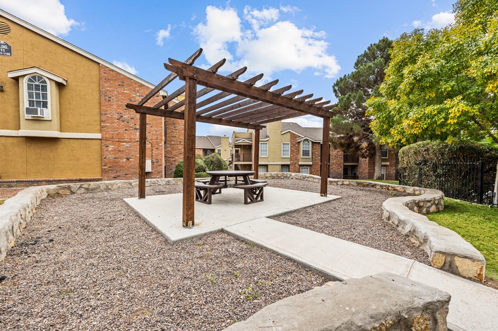 a picnic area with a picnic table in a courtyard