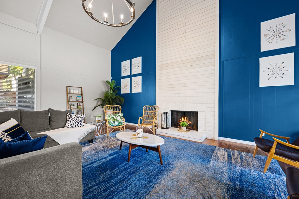 a living room with blue walls and a fireplace