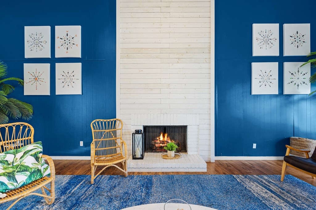 a living room with a fireplace and blue walls