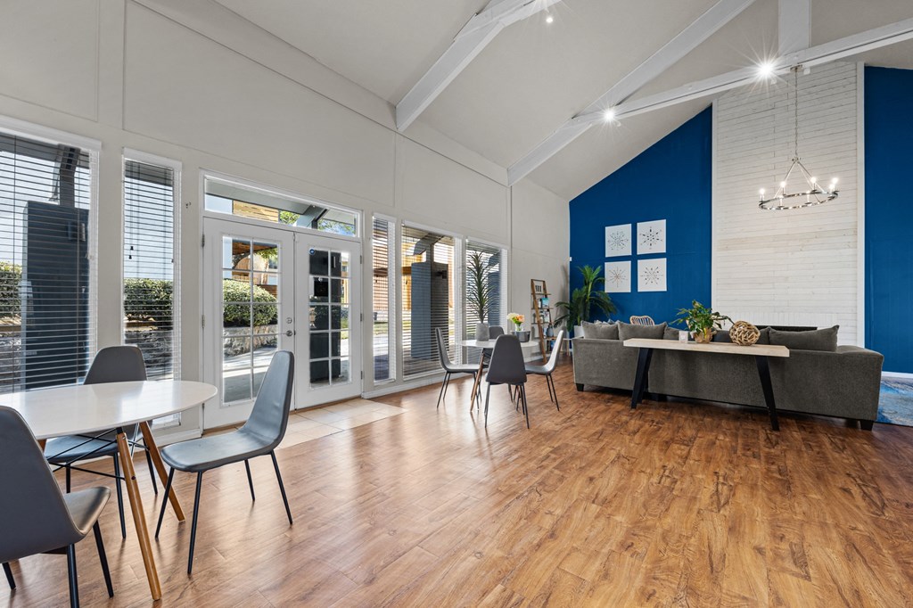 a living room with a dining room table and a couch
