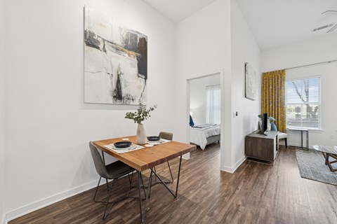 A dining room with a wooden table and chairs.