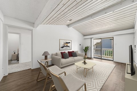A living room with a couch, chairs, and a coffee table.