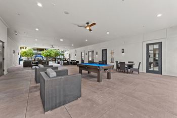 A spacious outdoor area with a pool table and seating.