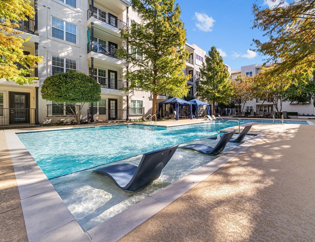 a swimming pool in front of an apartment building