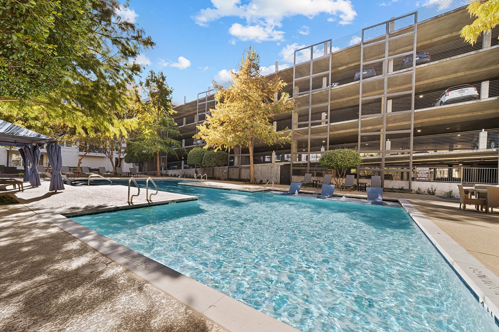 a swimming pool in front of an apartment building