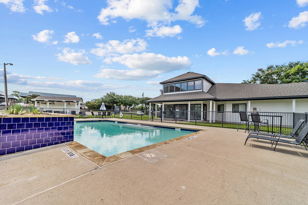 A blue wall borders a rectangular pool.