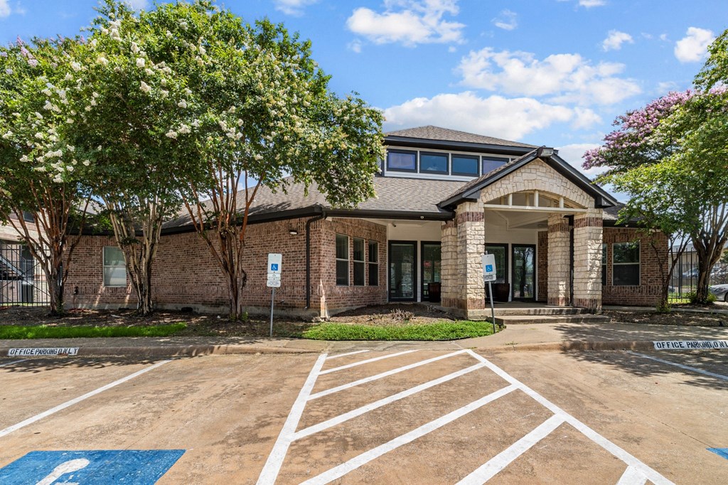 A building with a parking lot in front of it.