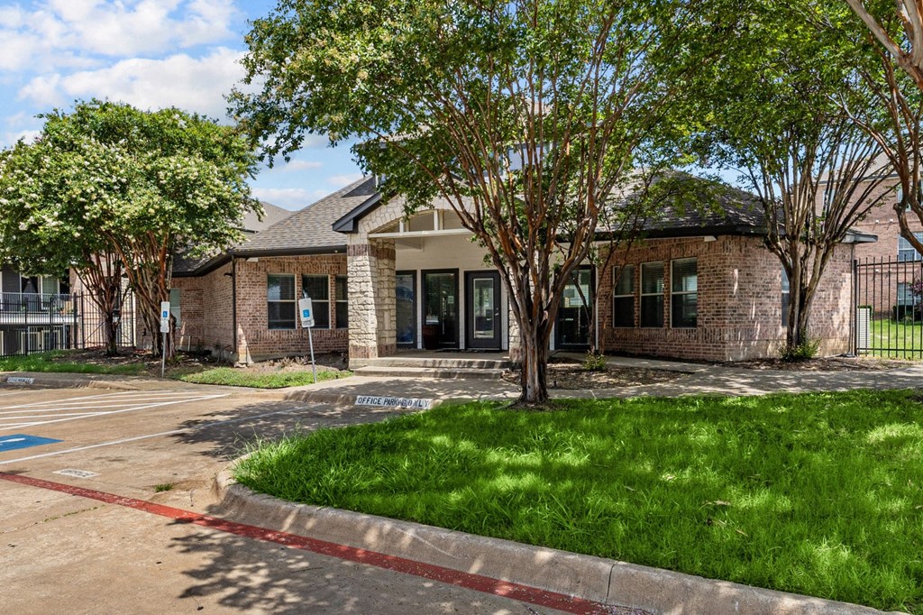 A building with a parking lot in front of it.