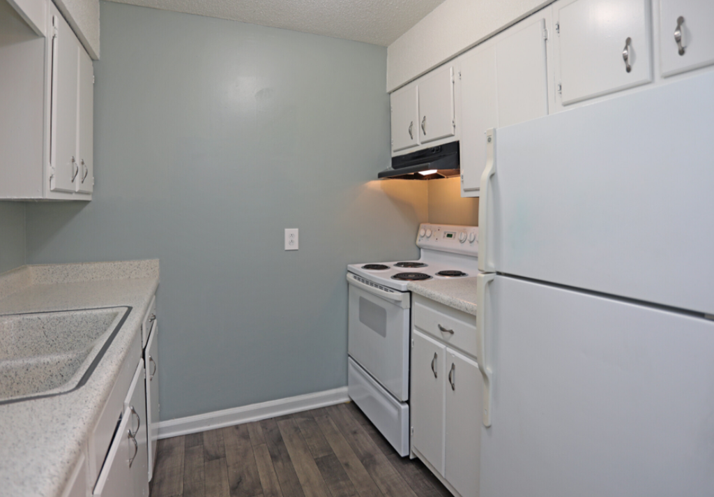 a kitchen with white appliances and white cabinets
