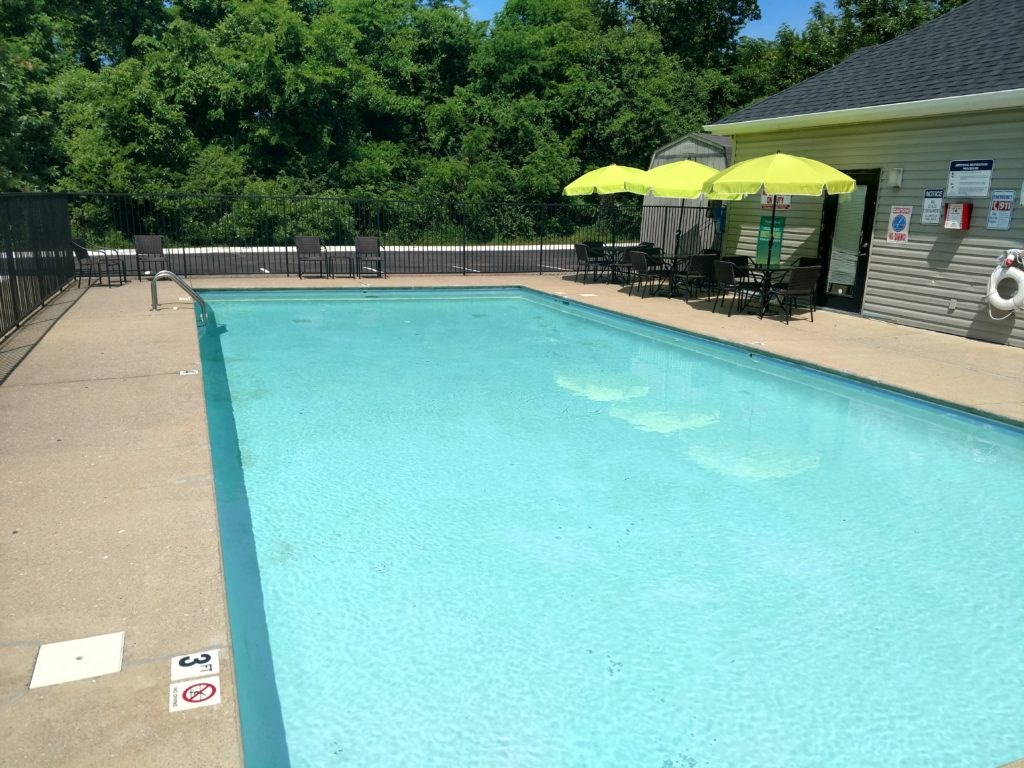 a swimming pool with umbrellas and chairs around it