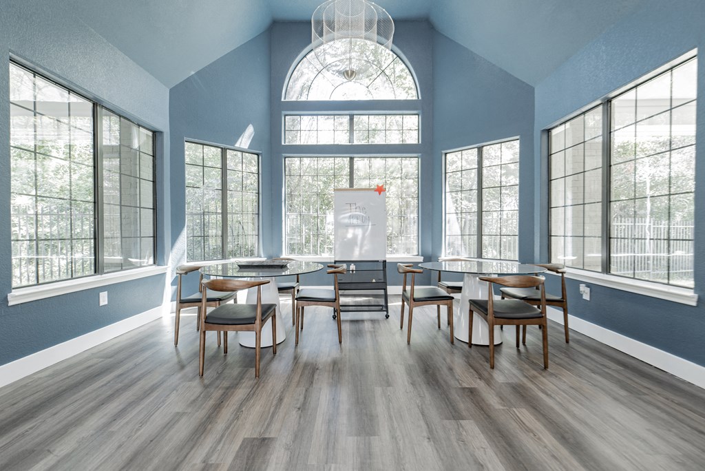 a dining room with a large window and tables and chairs