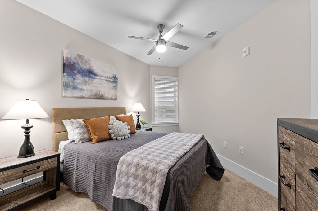 a bedroom with a bed and a ceiling fan