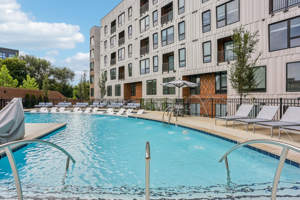 A large swimming pool in front of a modern building.