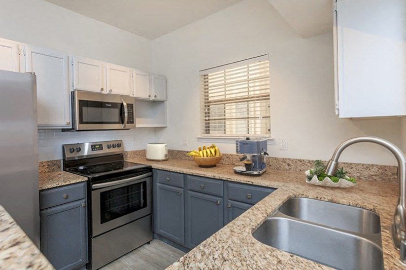 a kitchen with stainless steel appliances and granite counter tops