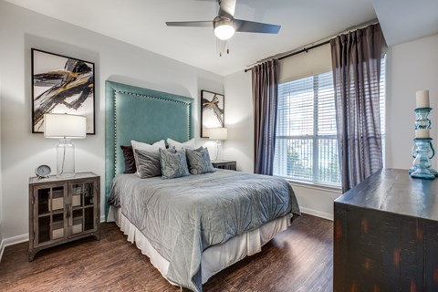 a bedroom with a large bed and a ceiling fan
