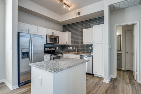 a kitchen with stainless steel appliances and a granite counter top